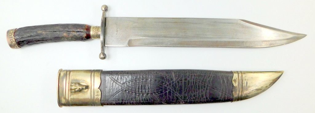 Bowie knife with stag handle selling at auction